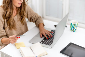 A woman using card on laptop