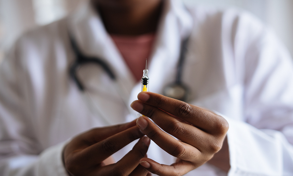 medical professional holding syringe