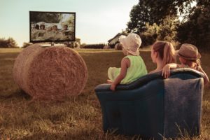 family watching tv in hayfield