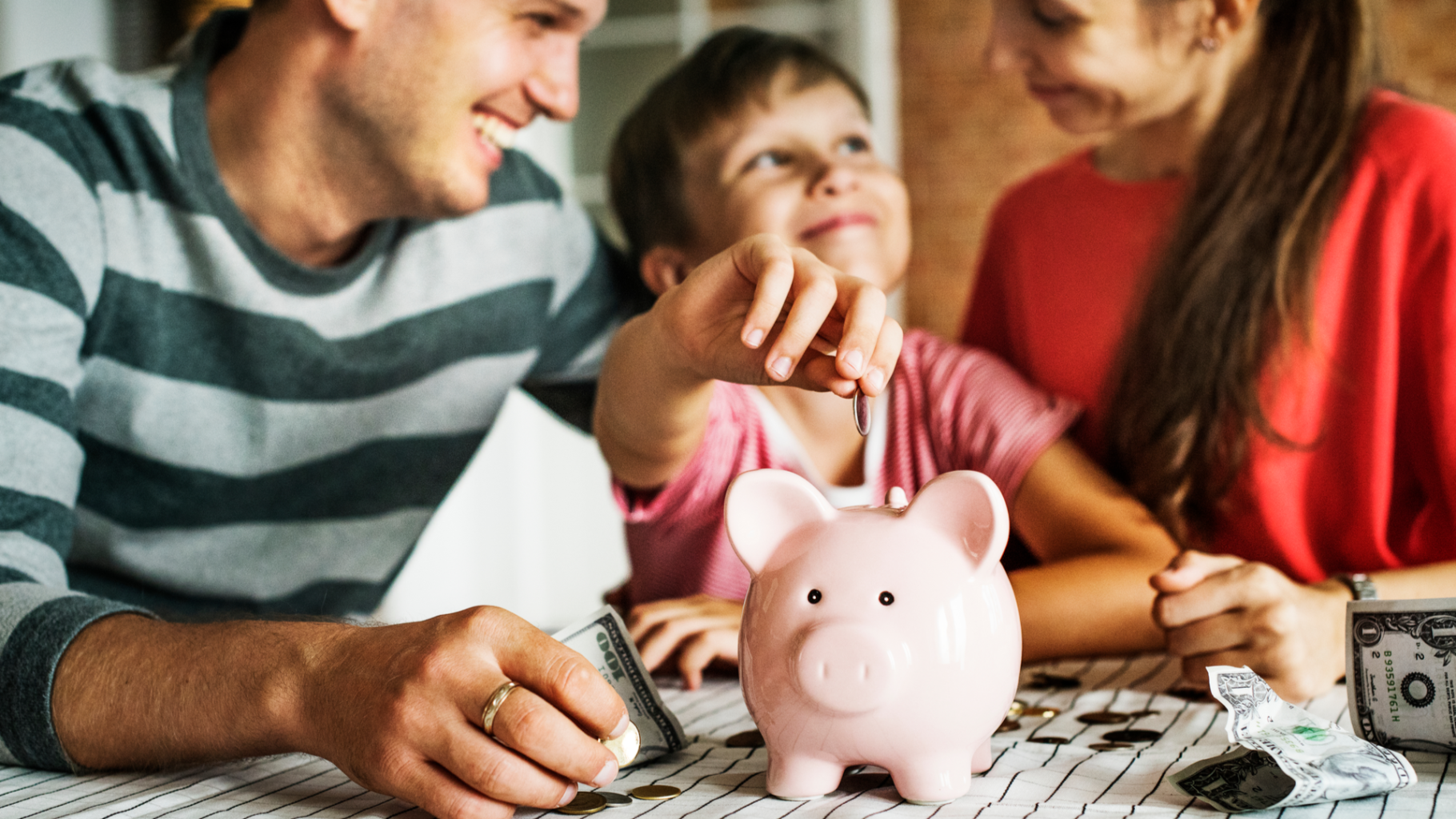 family saving money in piggy bank