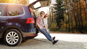 People In The Fall Sitting On Back Of Vehicle